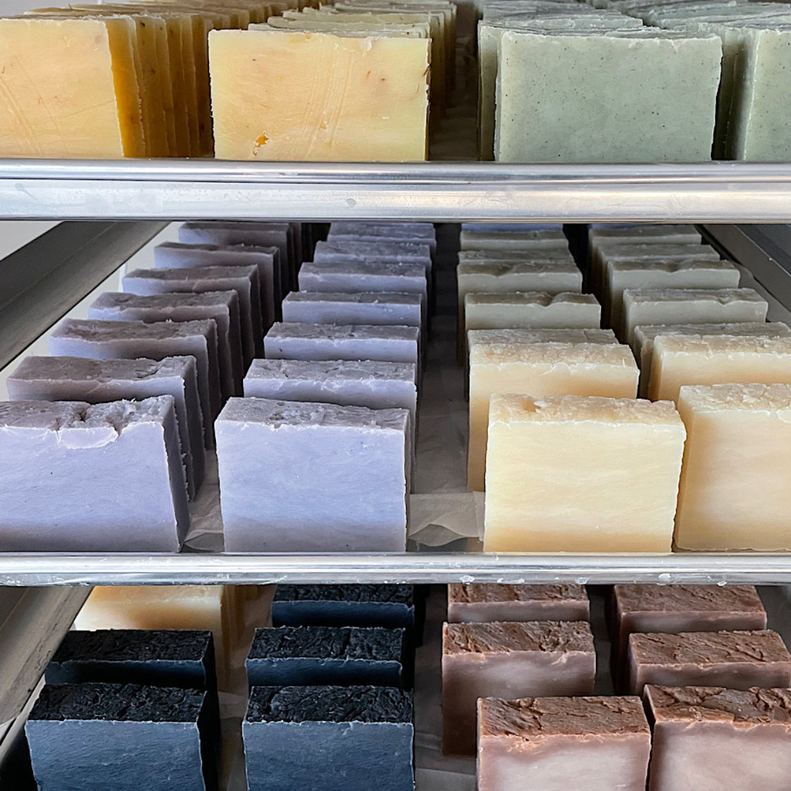 Four handmade soaps arranged for a luxurious exfoliating and cleansing experience