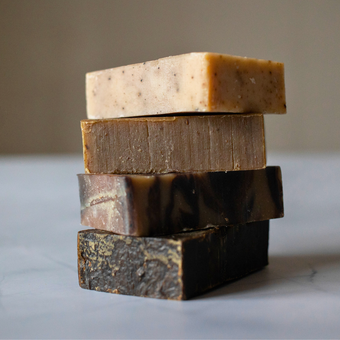 Four handmade soaps for sensitive skin displayed with eco-friendly packaging