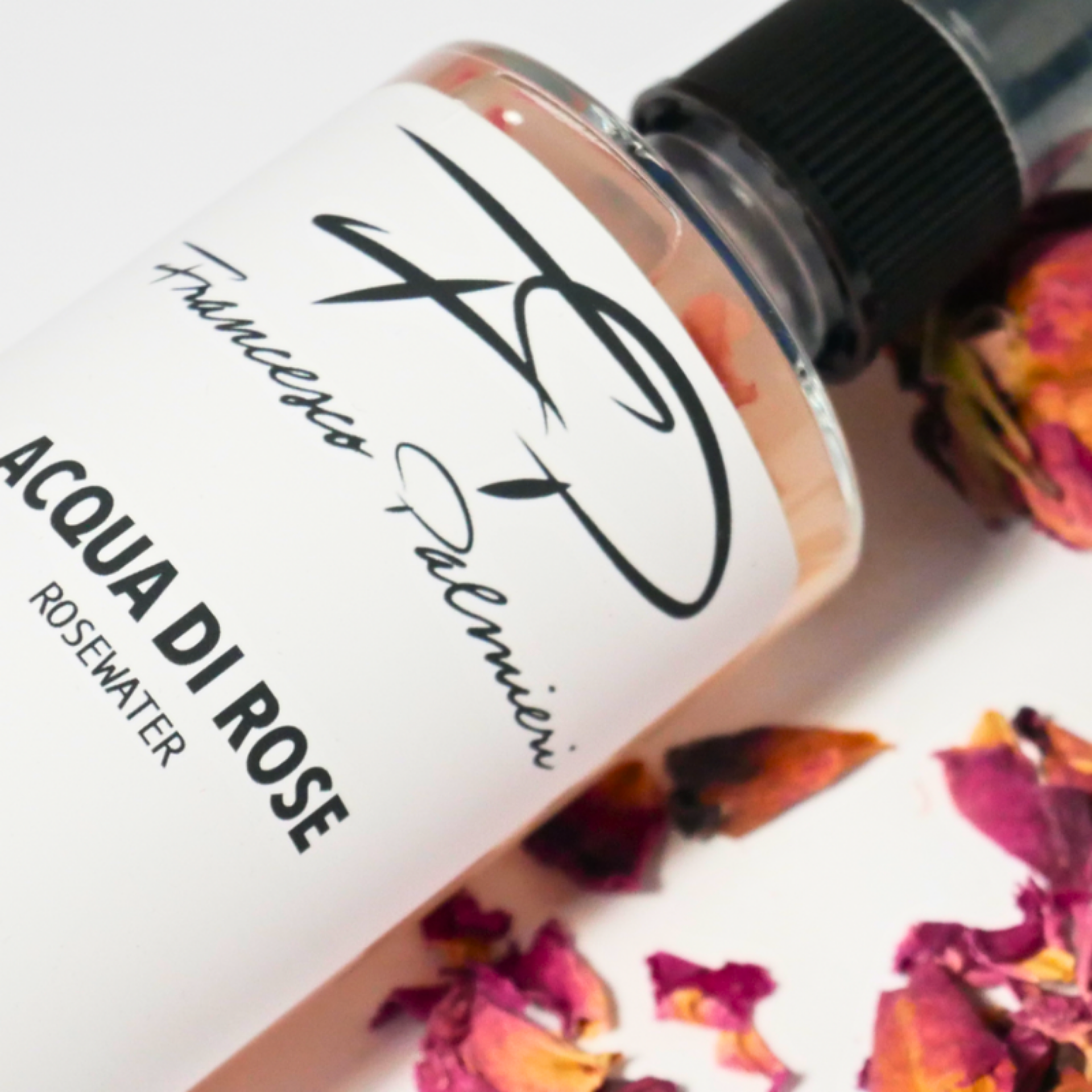 Aqua di Rose natural toner displayed with fresh rose petals