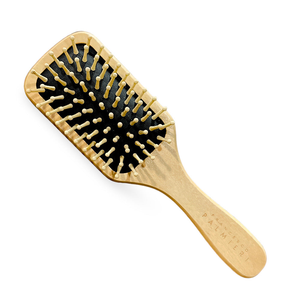 Bamboo Hairbrush displayed on a natural wooden surface