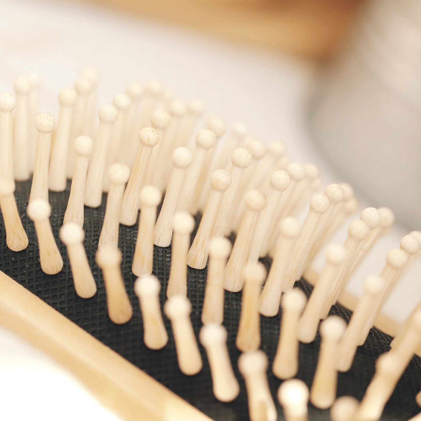 Detangling bamboo hairbrush with natural bristles for healthy hair.